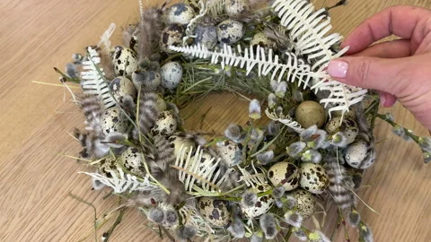 A woman shows a master class on creating an Easter wreath of a nest of willow an Vídeo Stock 304954354