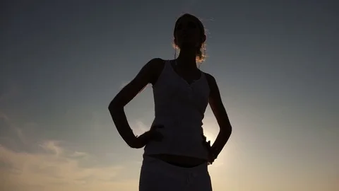 Woman silhouette dancing sensually at sunset Stock Footage