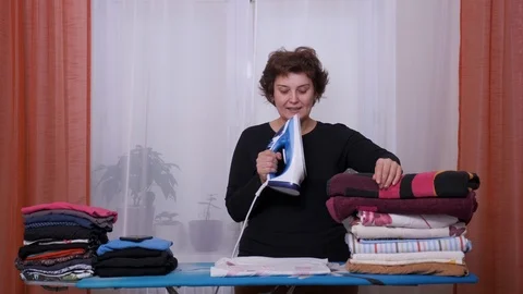 Woman sing while doing housework at home. Fun cute housewife ironing Stock Footage 122805667