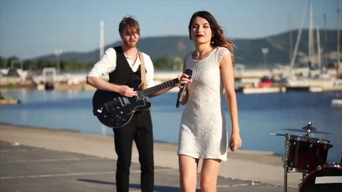 Woman singing during music band performance outdoor Stock Footage