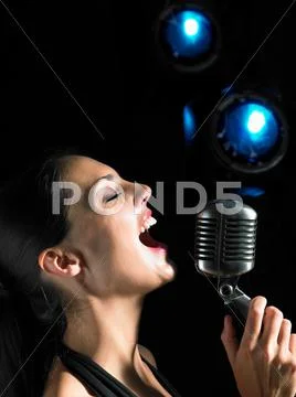 Woman Singing Into Microphone.