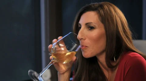 Woman sips wine at dinner Stock Footage 36765098