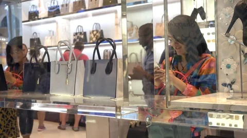 Woman sirch new Bag in a store - Shopping in Milan Stock Footage