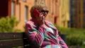 Woman sits on the bench and communicates via cell phone HD Footage