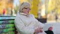 Woman sits on the bench and communicates via tablet PC HD Footage
