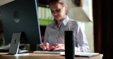 A woman sits at a computer on the table ionizer, close-up Stock Footage 236403051