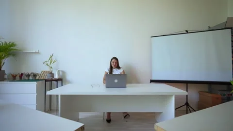 Woman sits in empty audience preparing for conference Stock Footage 202245413