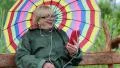 Woman sits on the swing bench and communicates via smartphone HD Footage