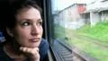 Woman sits in train near window during movement HD Footage