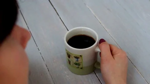 Woman sitting and dreaming holding coffee Stock Footage 71832653