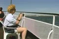Woman sitting and taking photos on tour boat Footage