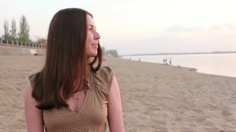 Woman sitting on the beach Stock Footage