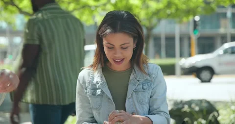 Woman sitting bench, glancing left, lifting lid from plastic tub, mixing salad Stock Footage 334924717