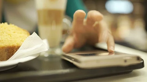 Woman sitting in the cafe and looks irritated, steadycam shot Stock Footage