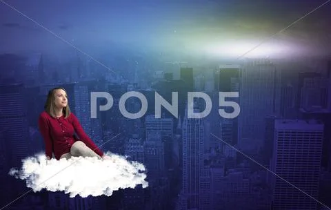 Woman sitting on cloud above the city Stock Photos