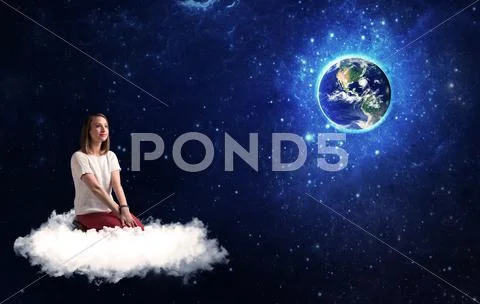 Woman sitting on cloud looking at planet earth Stock Photos