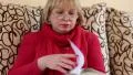 Woman sitting on a couch flipping through the pages of a big book HD Footage
