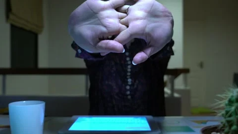 A woman is sitting at a desk and using a tablet Video stock 318914747