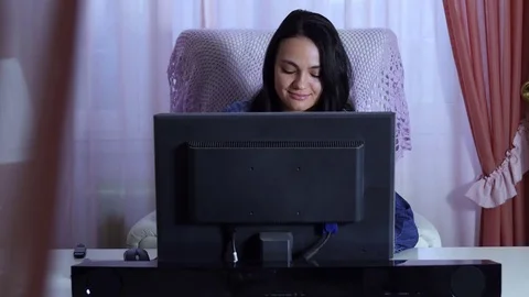 Woman sitting at the desk using the computer does homework Stock Footage 72630885