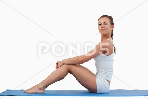 Woman sitting on a foam mat Stock Photos