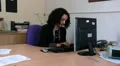 Woman sitting at her desk on the computer HD Footage