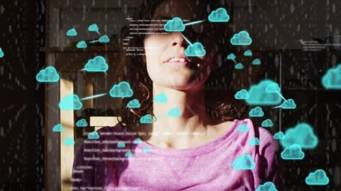 Woman sitting home as frames moving cloud icons layering around her and code Stock Footage 333132887