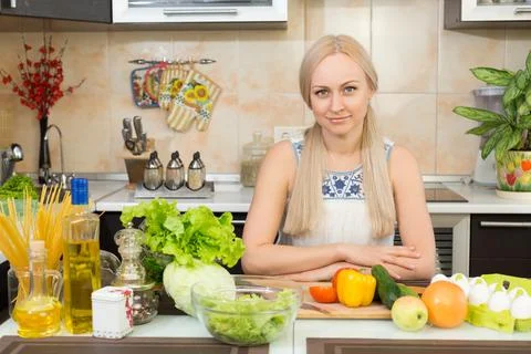 Woman sitting at the kitchen table Stock Photos