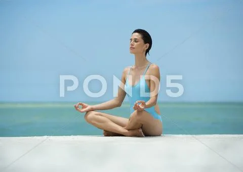 Woman Sitting In Lotus Position, On Beach