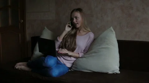 Woman sitting at sofa and using laptop Stock Footage 65471743