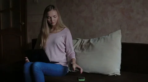 Woman sitting at sofa and using laptop Stock Footage 65472013