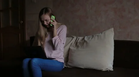 Woman sitting at sofa and using laptop Stock Footage 65472324