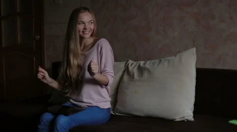 Woman sitting at sofa and using laptop Stock Footage 65474356
