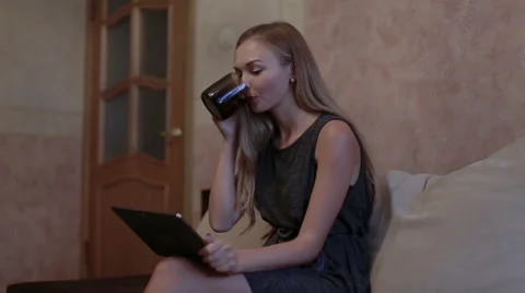 Woman sitting at sofa and using laptop Stock Footage 65474866
