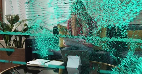 Woman sitting on sofa sorting tech docs and using tablet, causing teal data Stock Footage 322523512