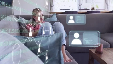 Woman sitting on sofa, watching system launching code, icons, profile cards for Stock Footage 334013971