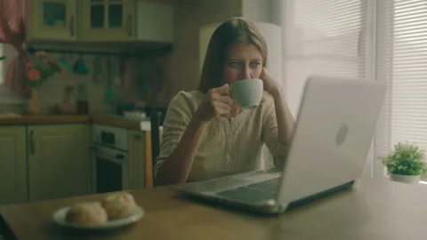 Woman Sitting At A Table Next To A Large Window At Home Stock Footage 150533729