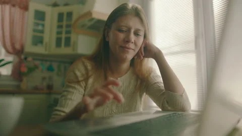 Woman Sitting At A Table Next To A Large Window At Home Stock Footage 150552981
