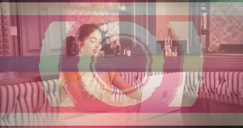 Woman sitting at table typing for remote work, midway glitches appearing, Stock Footage 321302020