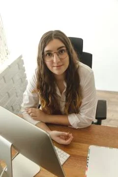 A woman sitting at a table using computer. Home office concept. Stock Photos