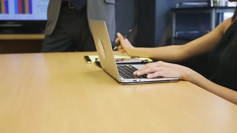 A woman sitting at a table using a laptop computer Stock Footage 155539697
