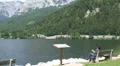 Woman sitting viewpoint alps lake landscape Austria HD Footage