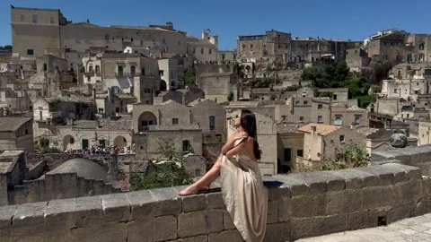 Woman Sitting on Wall Overlooking Sassi di Matera, Italy Stock Footage 336673052