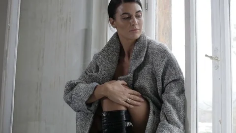 Woman sitting on window Видео 82213843