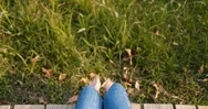 Woman Sitting On Wooden Path From Top View Stock Footage