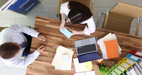 Woman sitting at workplace and refusing money in envelope in office top view Stock Footage 254178937