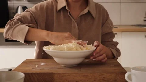 A woman skillfully prepares curdies using fresh cottage cheese Stock Footage 316768810