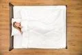 The woman sleeping on the bed. View from above Photo
