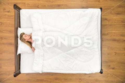 The woman sleeping on the bed. View from above Stock Photos