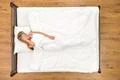 The woman sleeping on the bed. View from above Photo