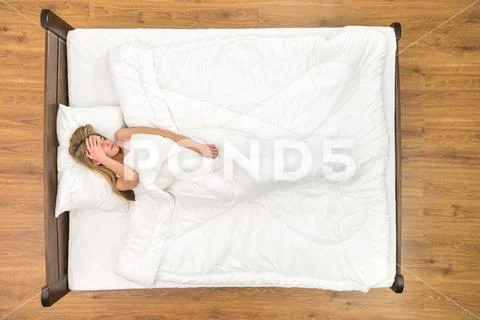 The woman sleeping on the bed. View from above Stock Photos